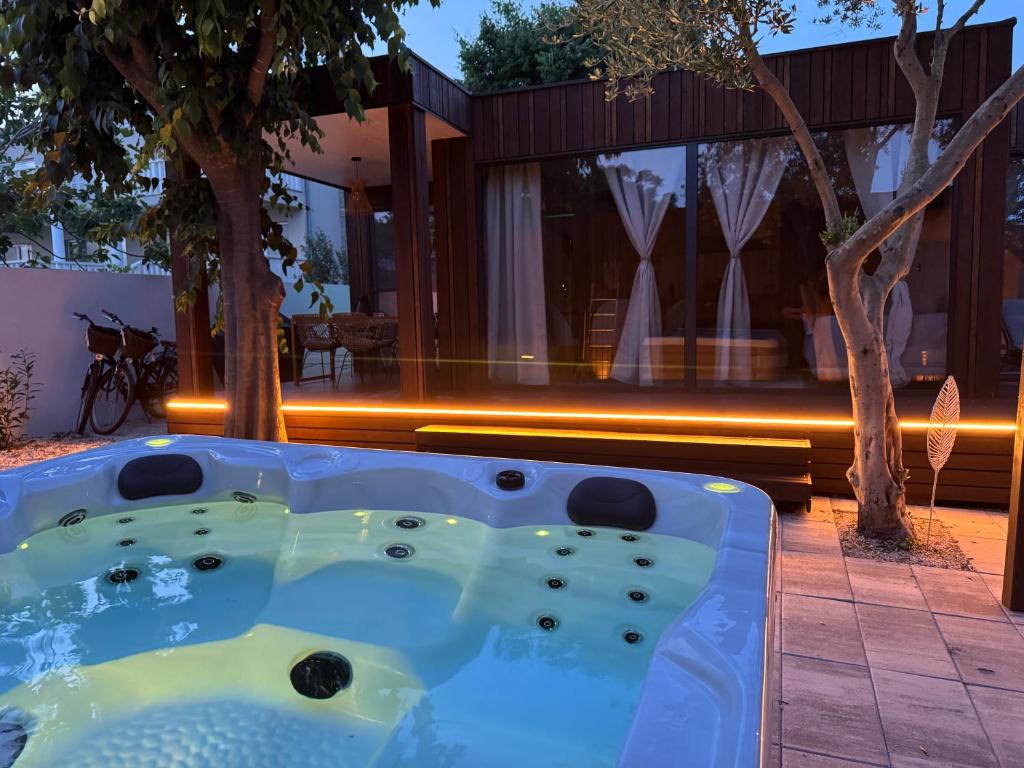 普利拉卡Prestige Beach & Wellness House的房屋后院的按摩浴缸
