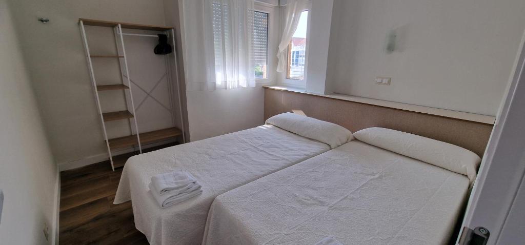 Postel nebo postele na pokoji v ubytování Apartamentos Suaces