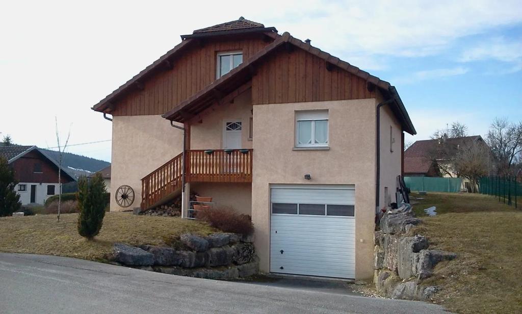 a house with a garage door in front of it at Appartement charmant près du lac à Saint-Point-Lac in Saint-Point-Lac