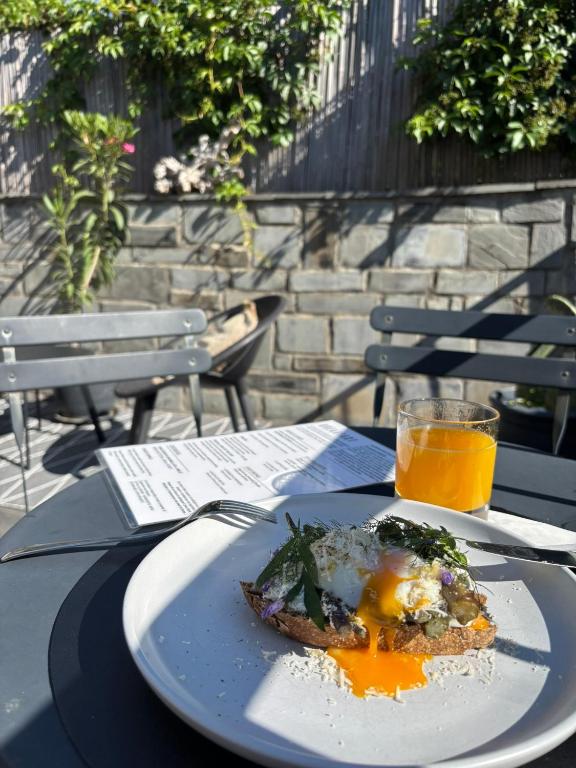 a plate of food on a table with a glass of orange juice at Locanda Il Carugio in Corniglia