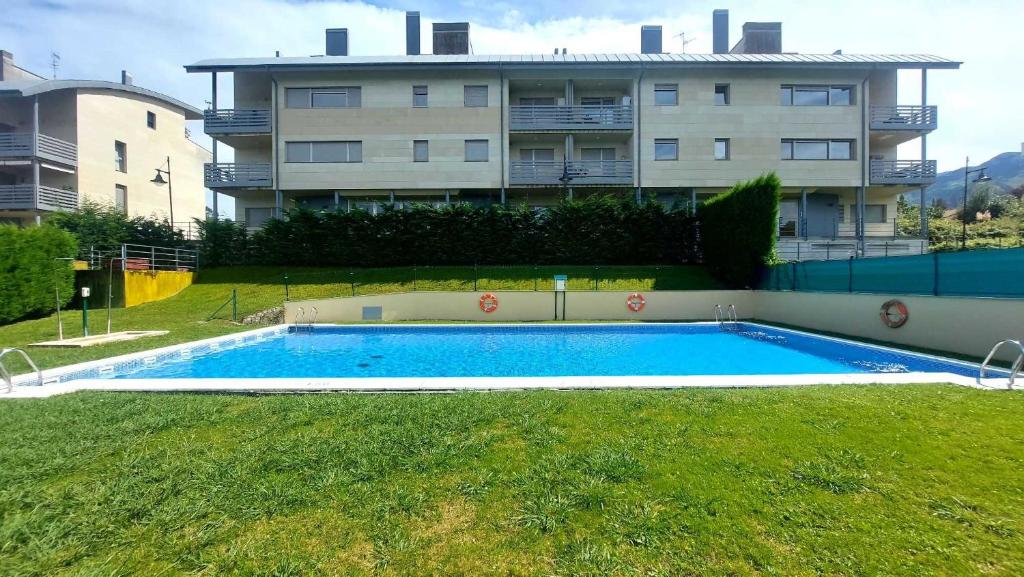 an empty swimming pool in front of a building at Apartamento Las Xanas in Llanes