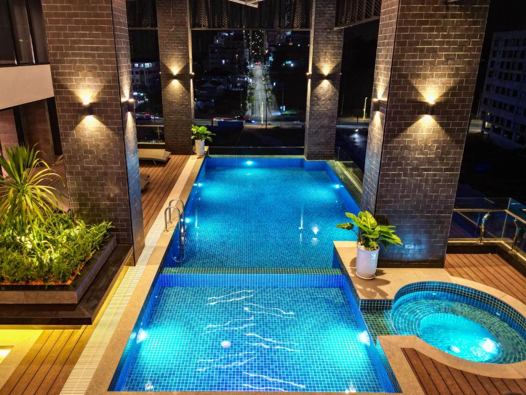 a swimming pool in a building with a night view at Grand La Vogue Hotel and Casino in Sihanoukville