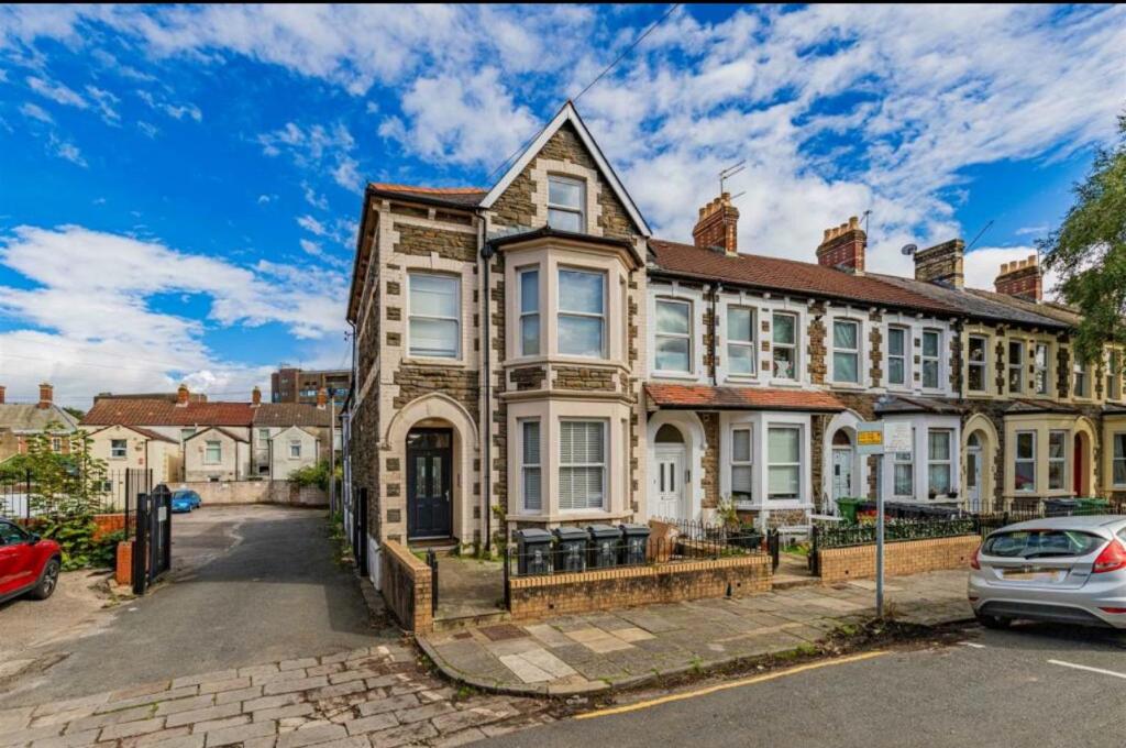 an old house with a car parked in front of it at 7-Min Walk to Principality and City Centre in Cardiff