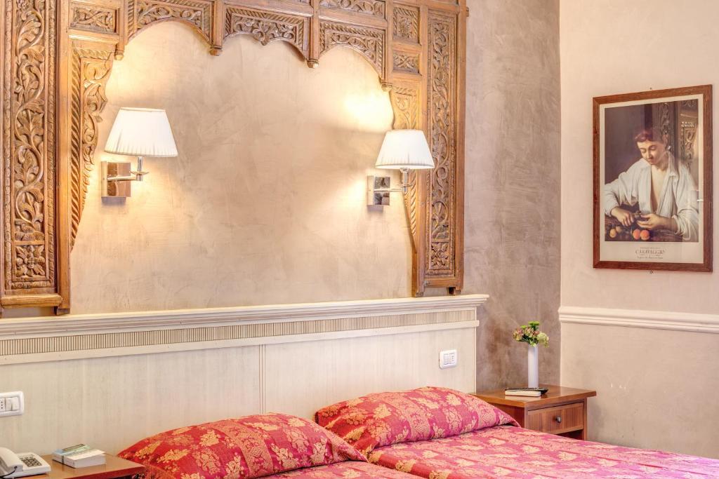 Postel nebo postele na pokoji v ubytování Hotel Caravaggio