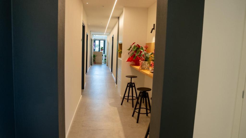 a hallway leading into a house with stools at CASA NEDA Affitacamere in Case Pieve al Toppo