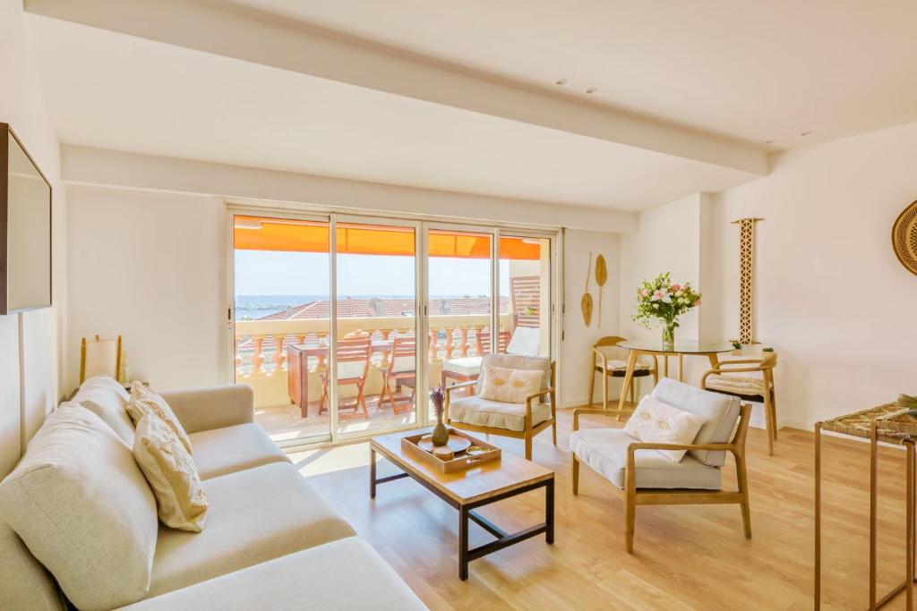 un salon avec un canapé et une table dans l'établissement LE VOILIER avec terrasse panoramique vue mer et port, proche du Palais, Croisette et plages, à Cannes