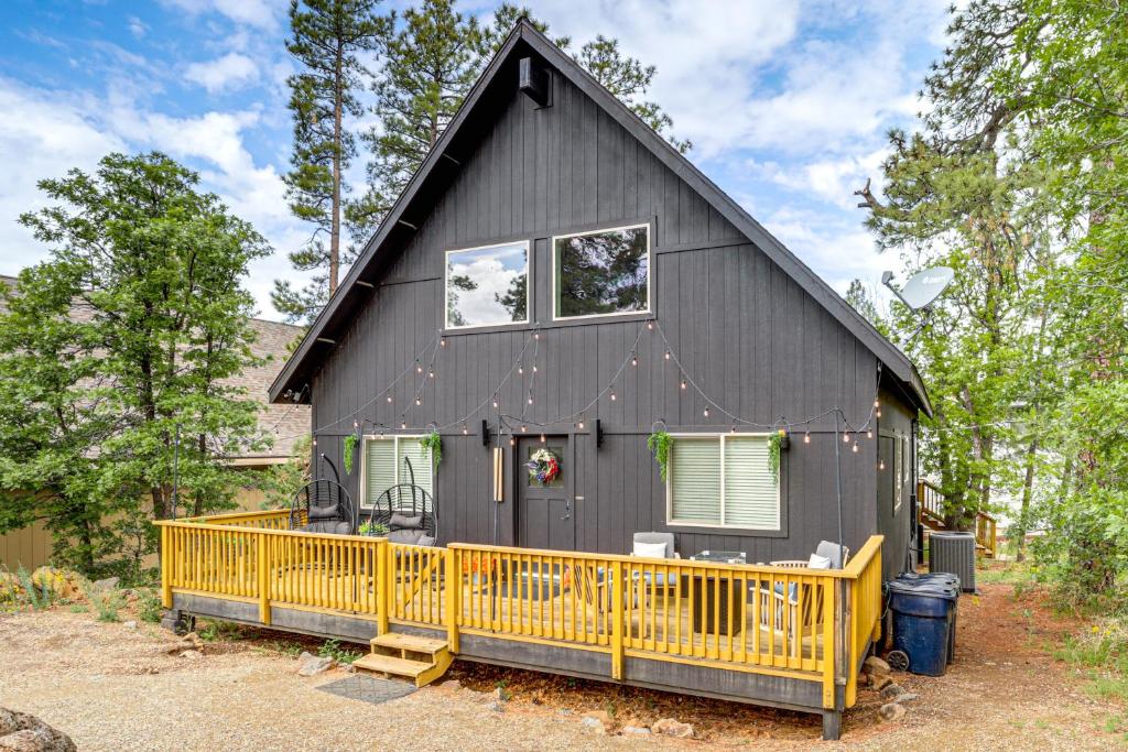a black house with a yellow front porch at Walk to Trails Modern Munds Park Mountain Retreat in Munds Park
