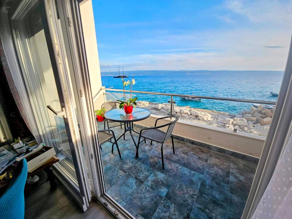 a balcony with a table and chairs and the ocean at Apartment Nemo in Jesenice