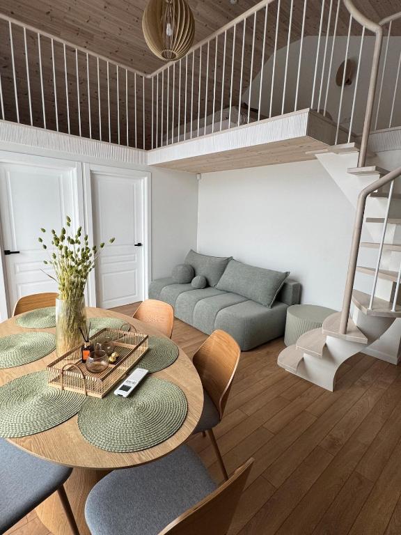 a living room with a table and a couch at Seaside apartment x Monciškės in Palanga
