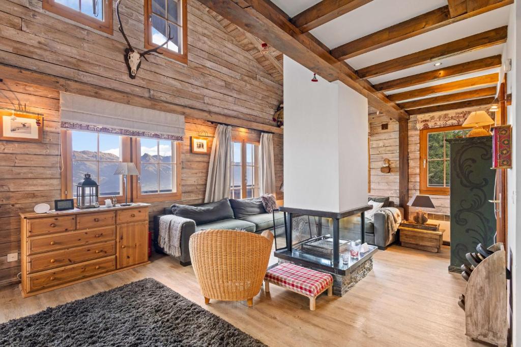 a living room with a couch and a fireplace at Marcotte - 8 pers - belle vue in Nendaz