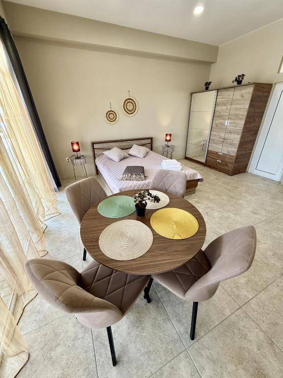 a room with a table and chairs and a bed at NM Residence in Shkorpilovtsi