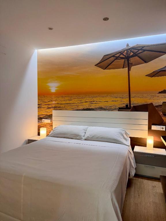 a bedroom with a large bed with an umbrella at Color Suites Alicante in Alicante