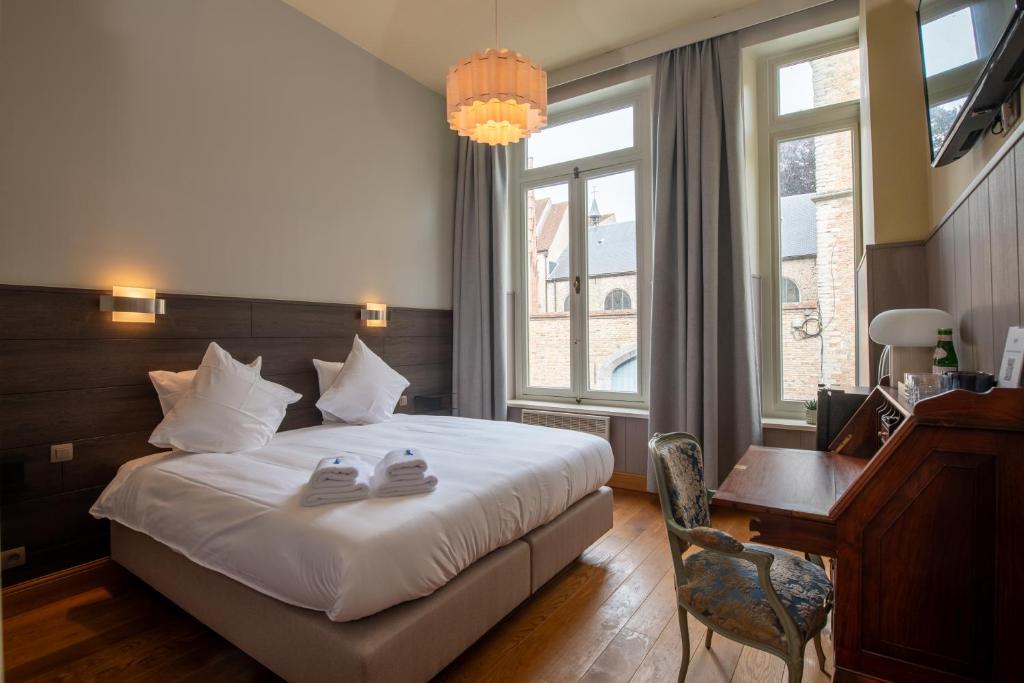 Postel nebo postele na pokoji v ubytování Hotel Lucca