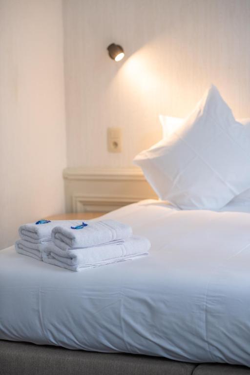 Postel nebo postele na pokoji v ubytování Hotel Lucca