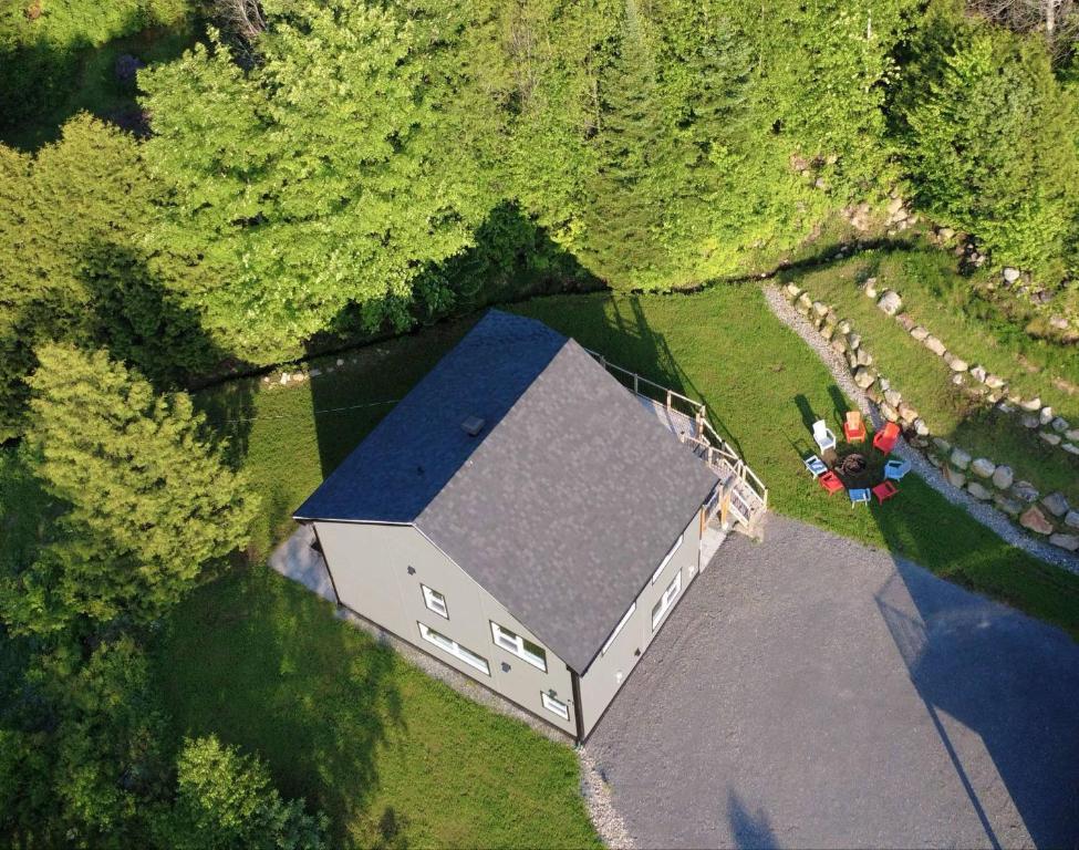 an aerial view of a house on the water at Domaine du Sous-Bois Condo complet in Saint-Faustin