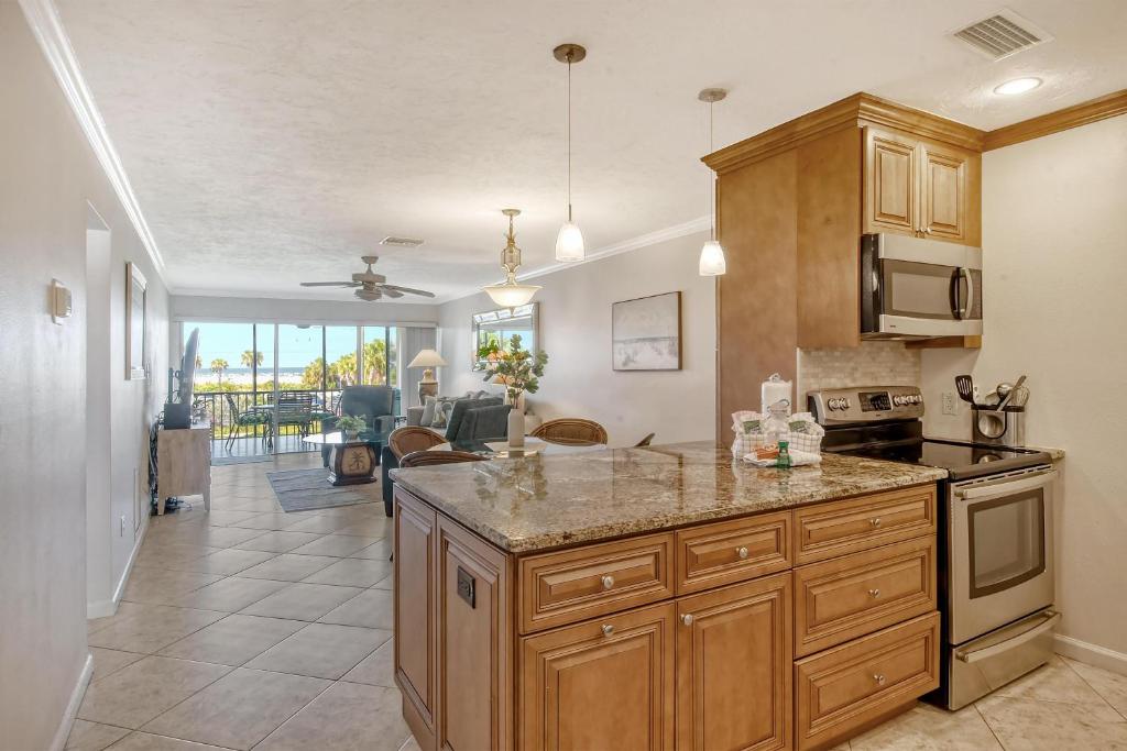 a kitchen with wooden cabinets and a counter top at Crescent Royale Condominiums 205 in Siesta Key