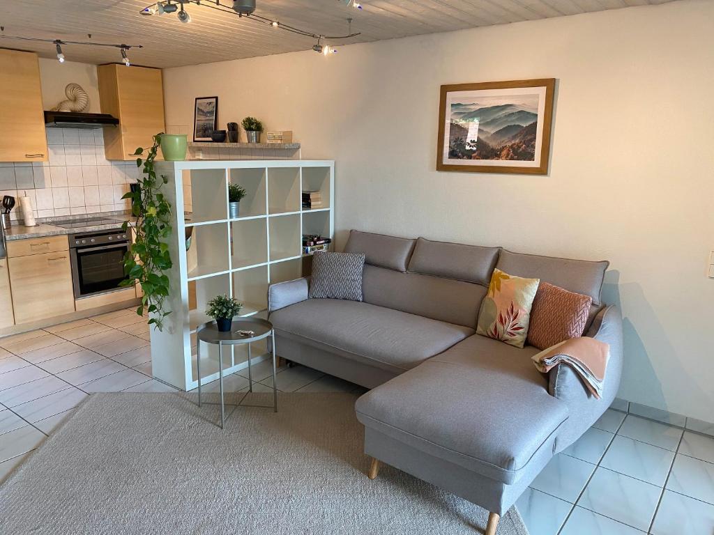 a living room with a couch and a table at Haus Höhneck in Alpirsbach