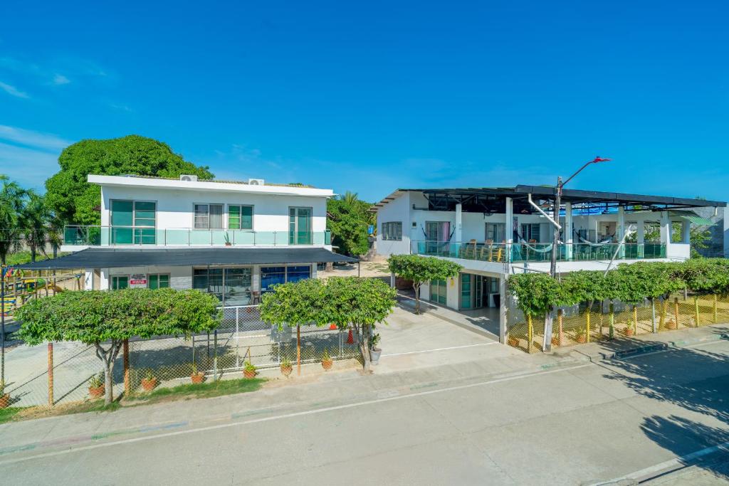 an aerial view of a white building with trees at Habitaciones Melany in Coveñas