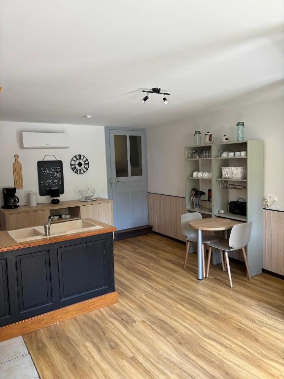a kitchen and dining room with a table and chairs at Odcvl - Le Moulin Gentrey in Harsault