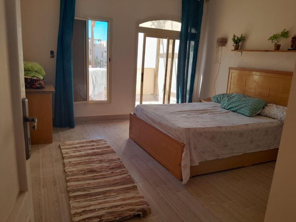 a bedroom with a bed and a large window at villa at blue lagoon resort rassudr for families only in Ras Sedr