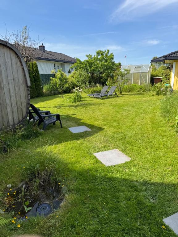 a park with a bench in the grass at Just Like Home Bed & Spa Porsgrunn in Porsgrunn