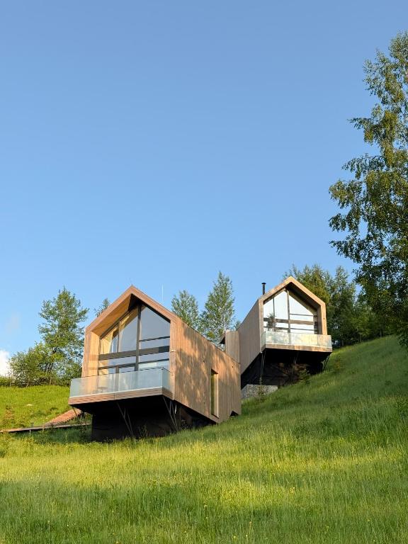 a house on top of a grassy hill at Vershe in Verkhovyna