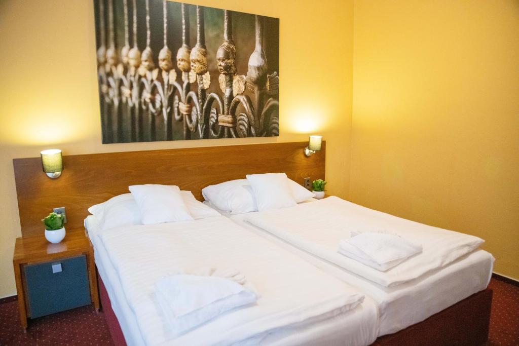 Postel nebo postele na pokoji v ubytování Hotel U Salzmannů