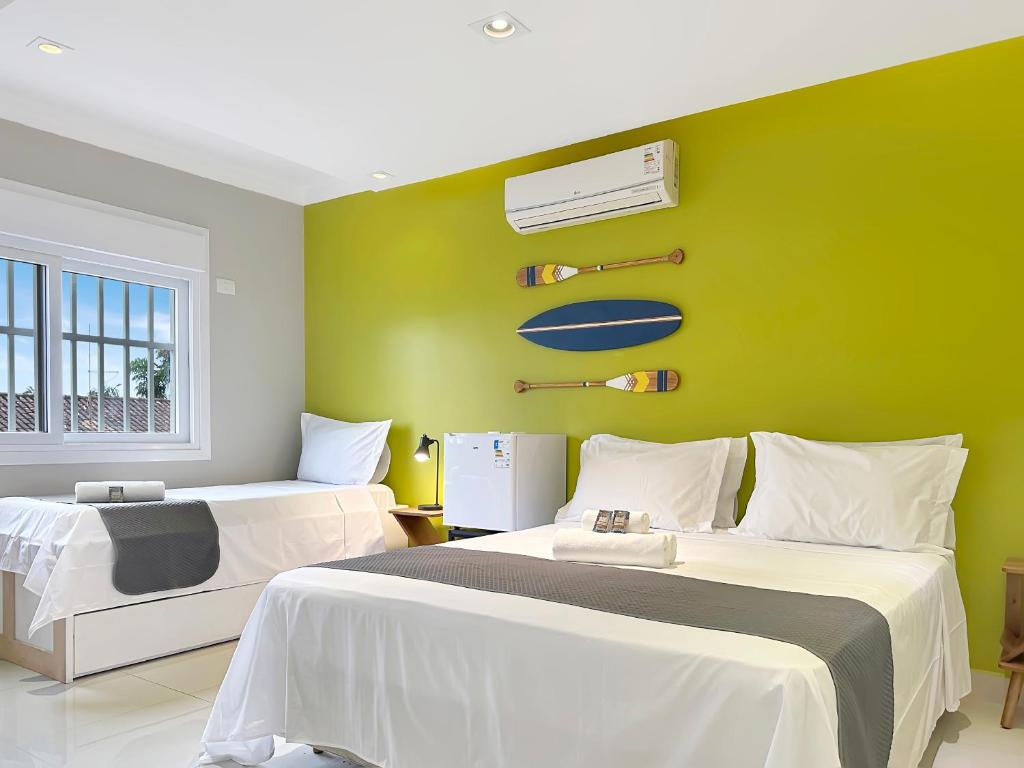 Ένα ή περισσότερα κρεβάτια σε δωμάτιο στο Piscina Churrasqueira Suíte 200m do Mar AC