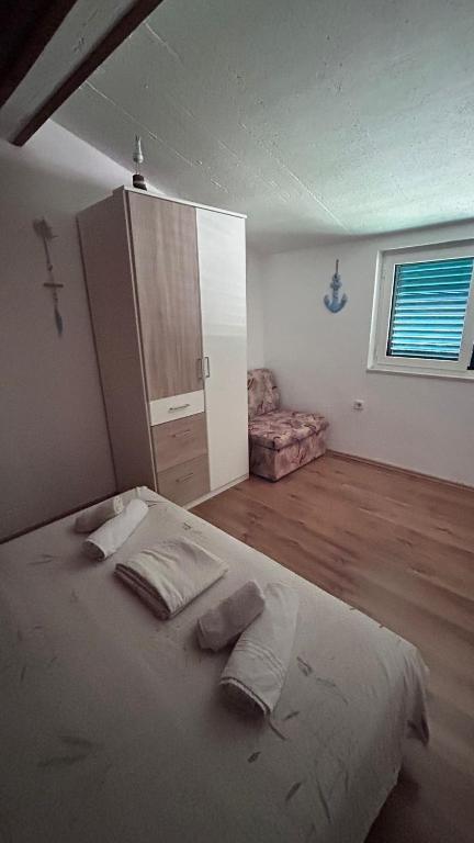 a bedroom with a bed with two pillows on it at Old Town Primošten in Primošten