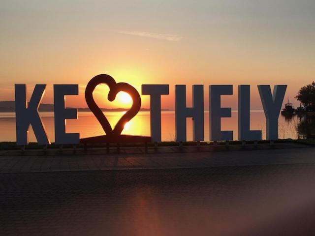 a large sign with a heart in the sunset at Balaton Vendégház Keszthely in Keszthely