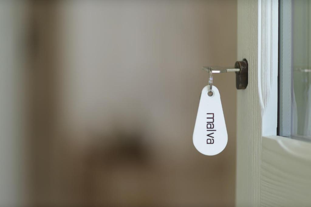 a door tag that says open on a door at Masseria Borgo Sentinella in Torre dell'Orso