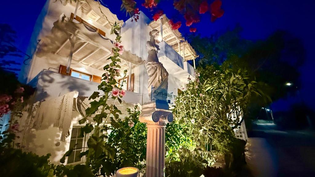 a street light in front of a white house at night at Deluxe Studios & Suites Ageri-Milos in Adamantas