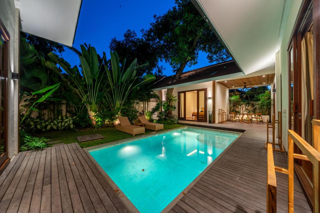 an indoor swimming pool in a backyard with a house at Private Pool - Serene Vibes - Perfect Bali Escape - Your home 3BDR Villa in Sanur