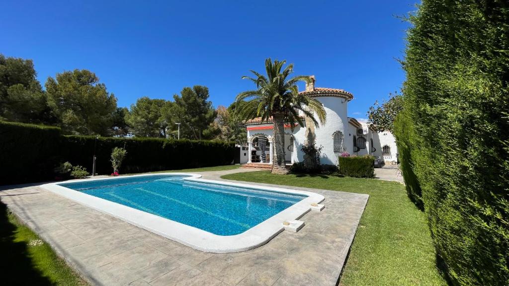 a villa with a swimming pool in front of a house at MEDDAYS Villa MARINA in Miami Platja