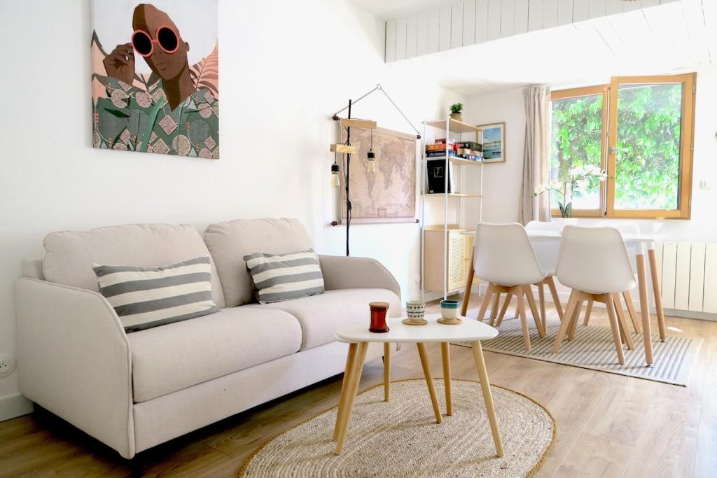 un salon avec un canapé blanc et une table dans l'établissement Parenthèse Andernosienne, à Andernos-les-Bains