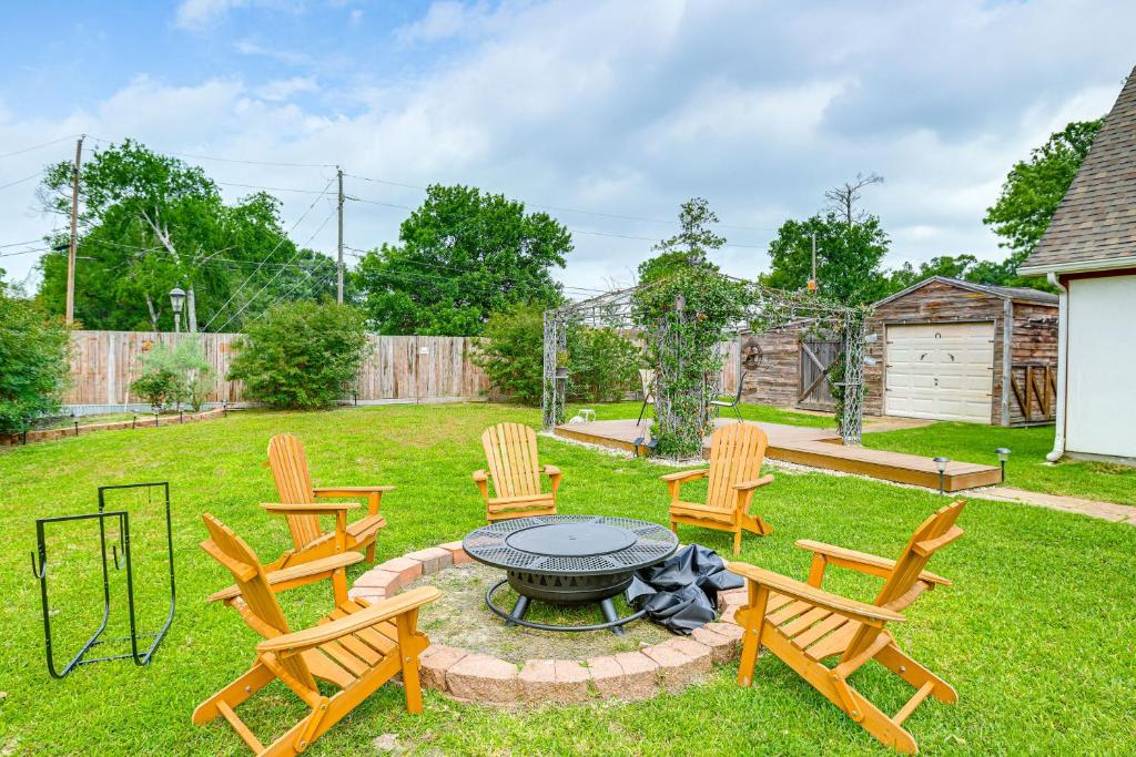 a group of chairs around a fire pit in a yard at Private Backyard Oasis Spacious Home in Humble! in Houston