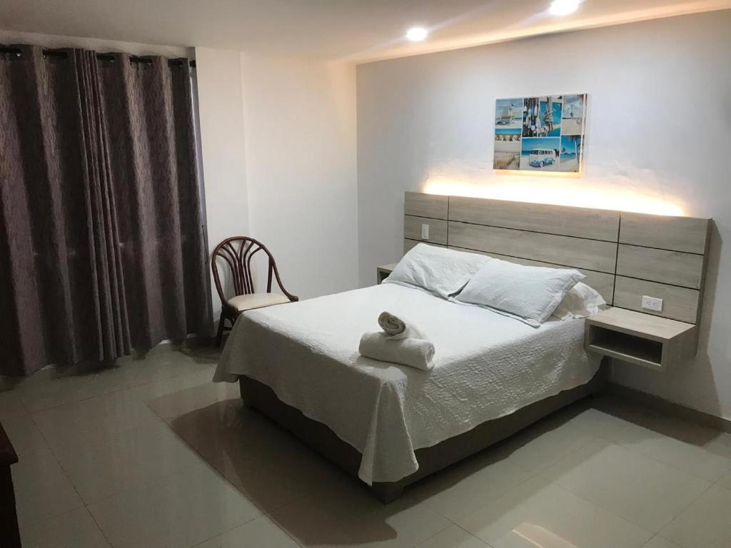A bed or beds in a room at Hostal Marlyn