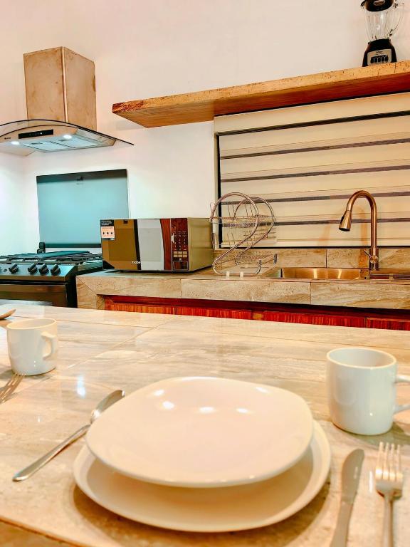 a white plate on a counter in a kitchen at Casa Bonita PXM in Puerto Escondido