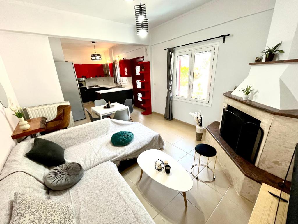 a living room with a couch and a fireplace at Τequila Sunrise in Áyios Pétros