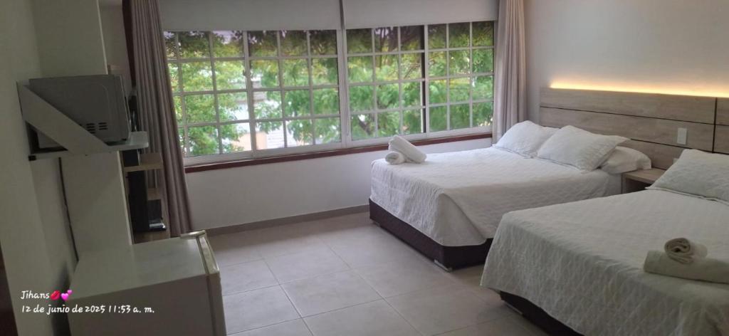 A bed or beds in a room at Hostal Marlyn