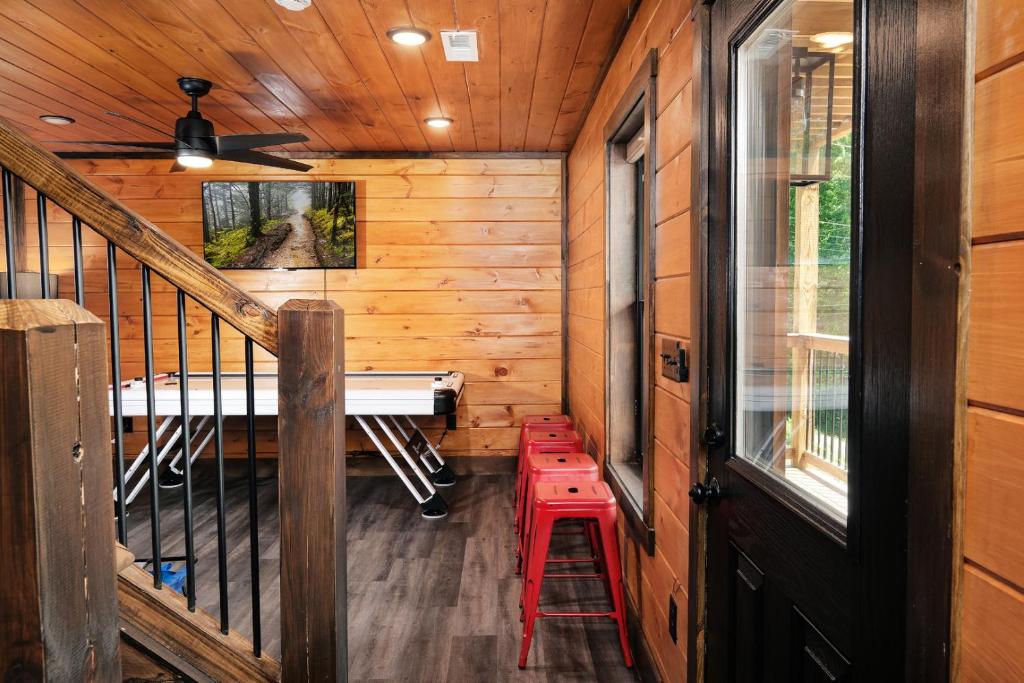 a tiny house with a staircase and a desk at Saving Grace Where the Mountains Save the Day in Pigeon Forge