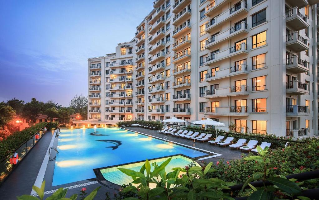 a large apartment building with a large swimming pool at Elegant Suites Westlake in Hanoi