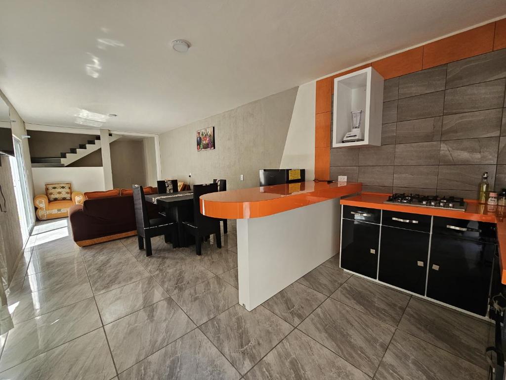a kitchen and living room with a counter top at El Riego Casa amplia, moderna y luminosa in Tehuacán