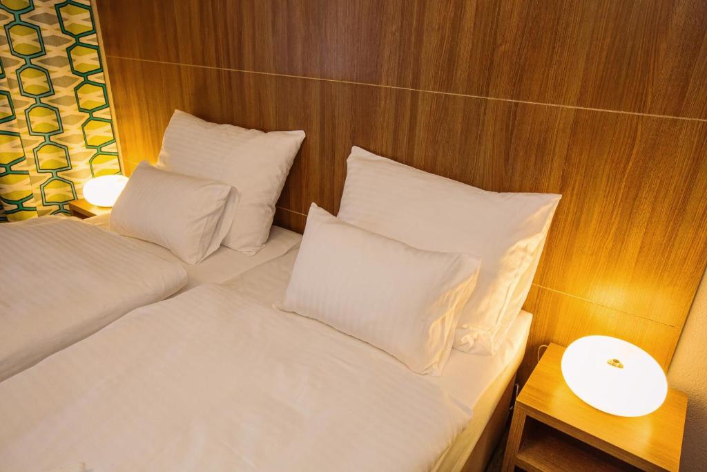 Postel nebo postele na pokoji v ubytování Hotel Na Šustně