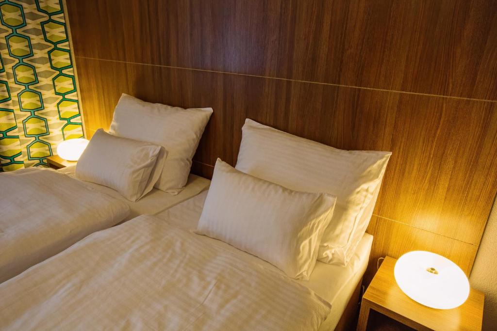 Postel nebo postele na pokoji v ubytování Hotel Na Šustně