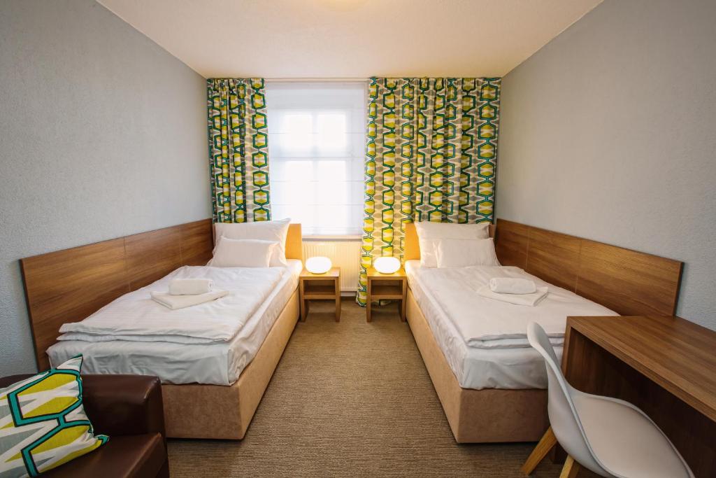 Postel nebo postele na pokoji v ubytování Hotel Na Šustně