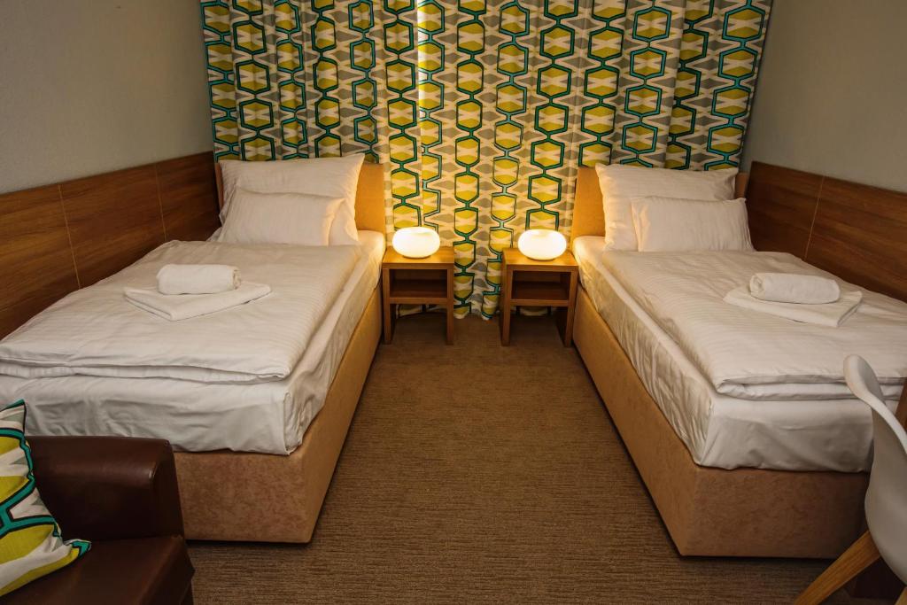 Postel nebo postele na pokoji v ubytování Hotel Na Šustně