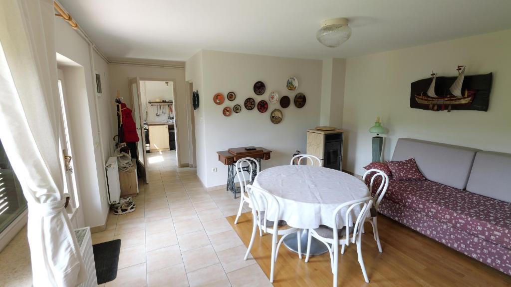 a living room with a table and a couch at Country House Trnac in Tuhelj