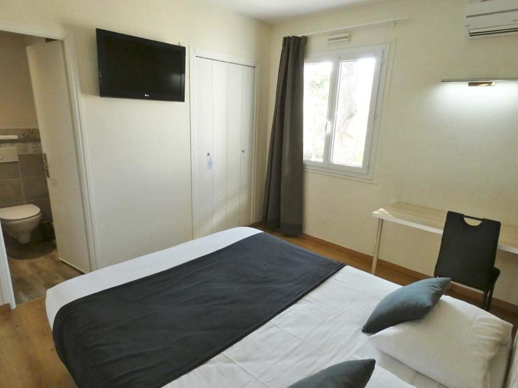 Postel nebo postele na pokoji v ubytování La Belle Hôtel
