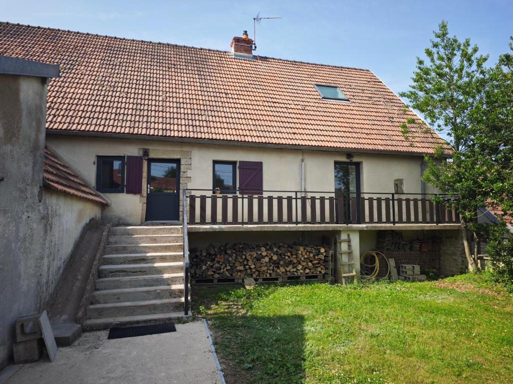 une maison avec une terrasse sur le côté dans l'établissement Gîtes des cerisiers, à La Celle-sous-Gouzon